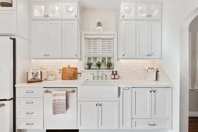 white kitchen with stainless steel appliances