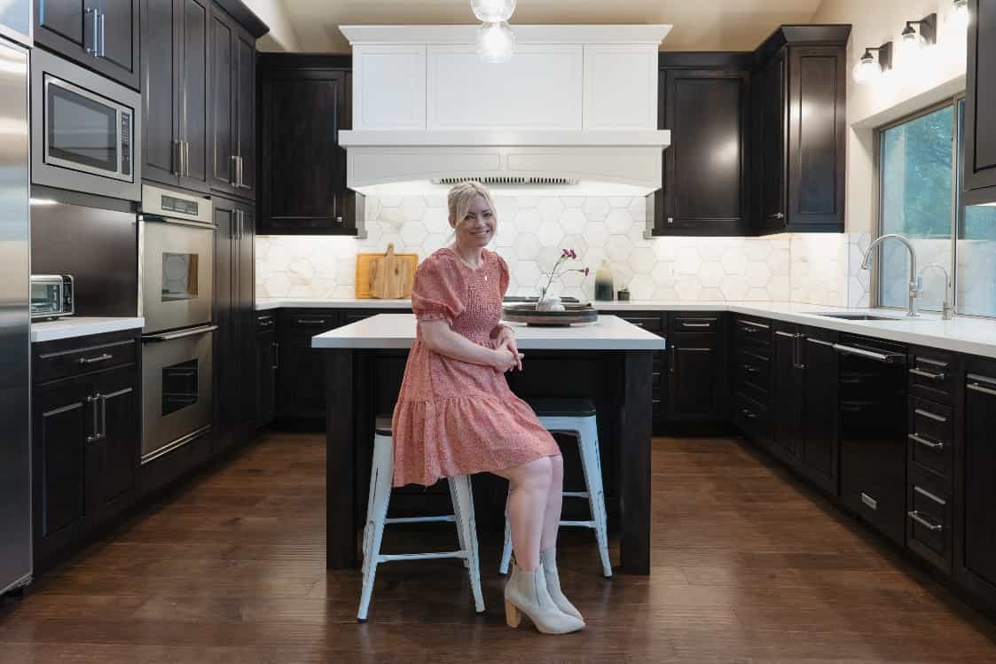 designer standing next to custom home media center