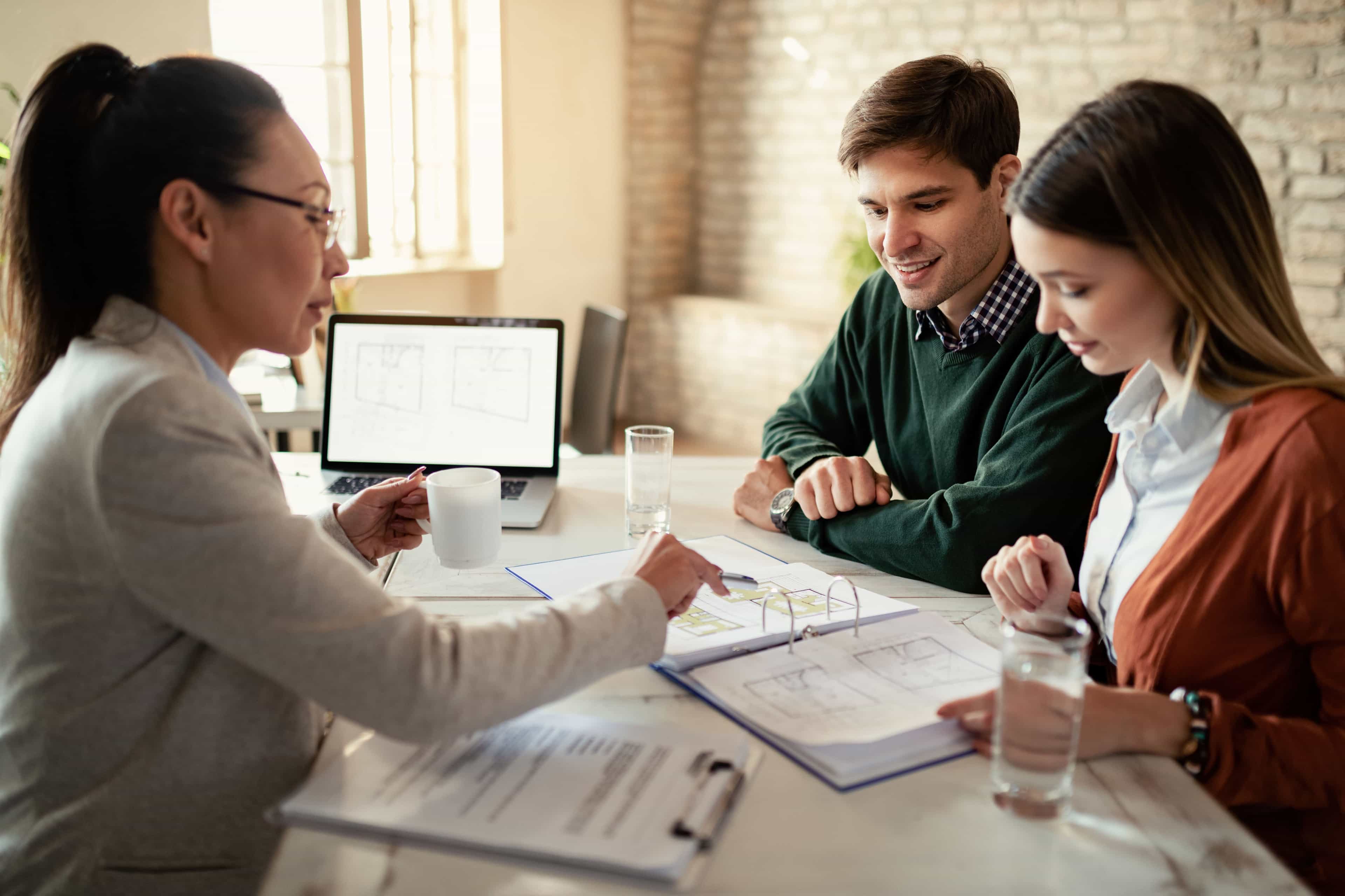 a designer going over plans with a couple