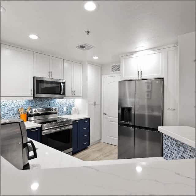 white counters with stainless steel appliances