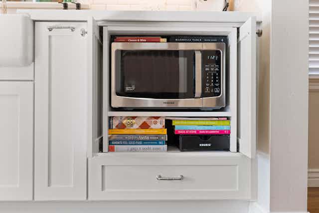 Microwave storage with white cabinets