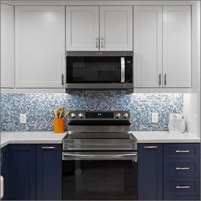 front view of stainless steel stove and blue cabinets