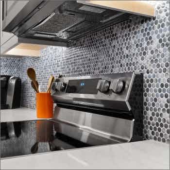 closeup of stainless steel stove and backsplash