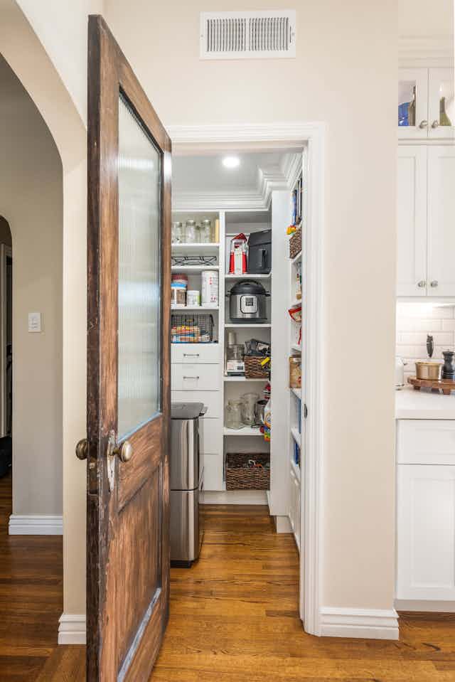 walk in pantry with white cabinets
